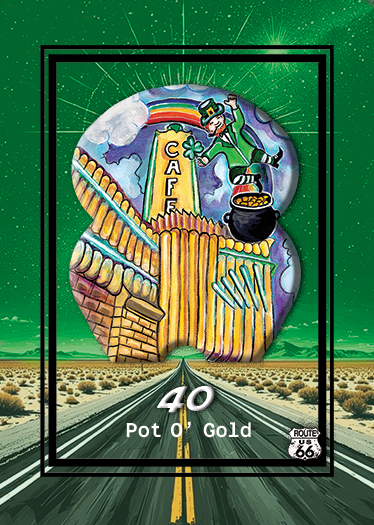 Colorful illustrated poster featuring a giant soda cup and building with a sign that reads 'CAFE' and a witch flying on a broomstick with a cauldron. The background has a road leading to a desert landscape and a starry green sky. The poster has the t