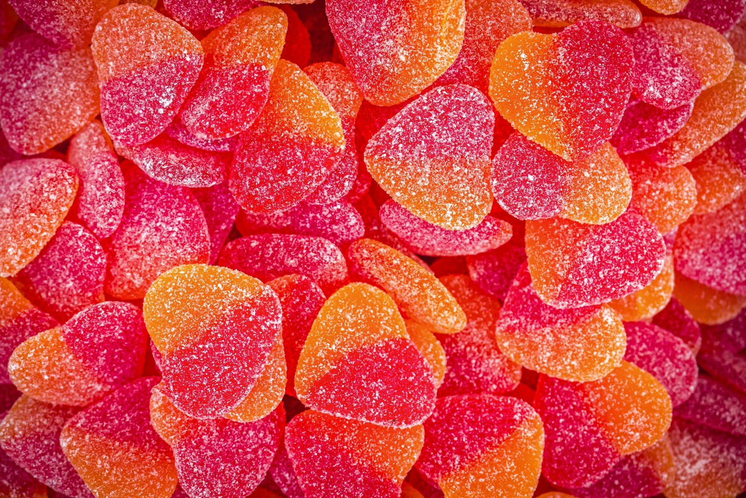 Close-up of sugared candies in orange and red.