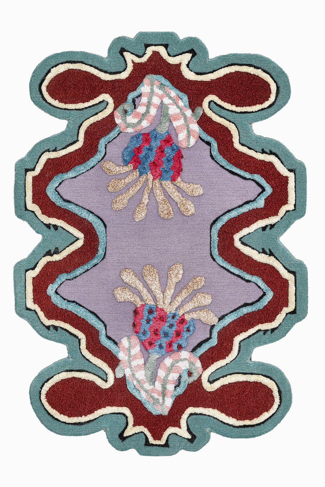A decorative embroidered rug with a symmetrical pattern featuring snakes, flowers, and a colorful border in shades of teal, red, white, purple, and beige.
