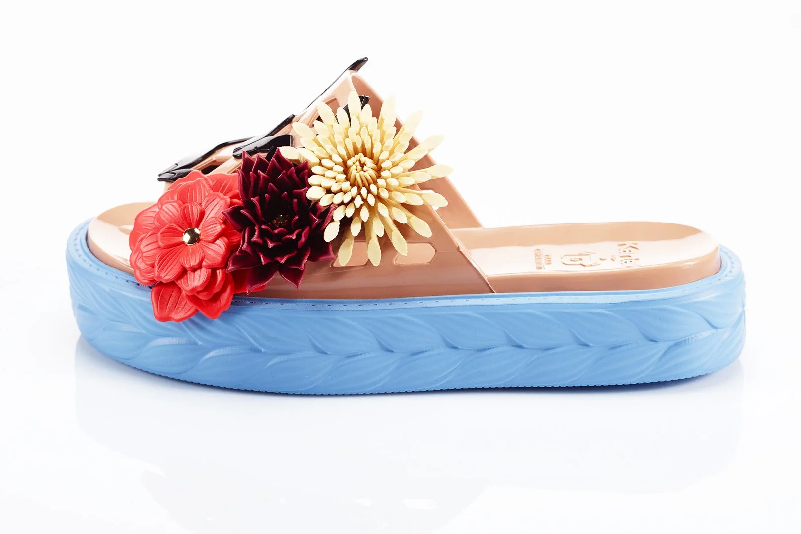 Platform sandal with large flower decorations on strap, blue sole, beige footbed