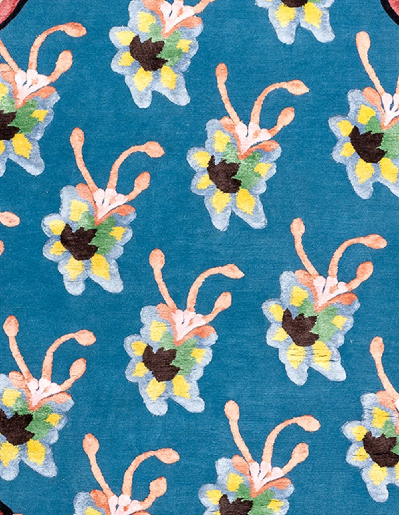 A fabric with a blue background, decorated with a pattern of stylized floral motifs in shades of yellow, white, green, and peach.