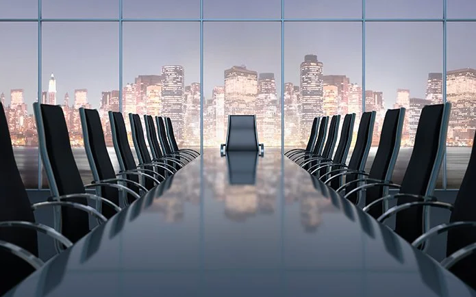 Empty boardroom with city skyline — representing the governance and decision-making environments Ascent advises.