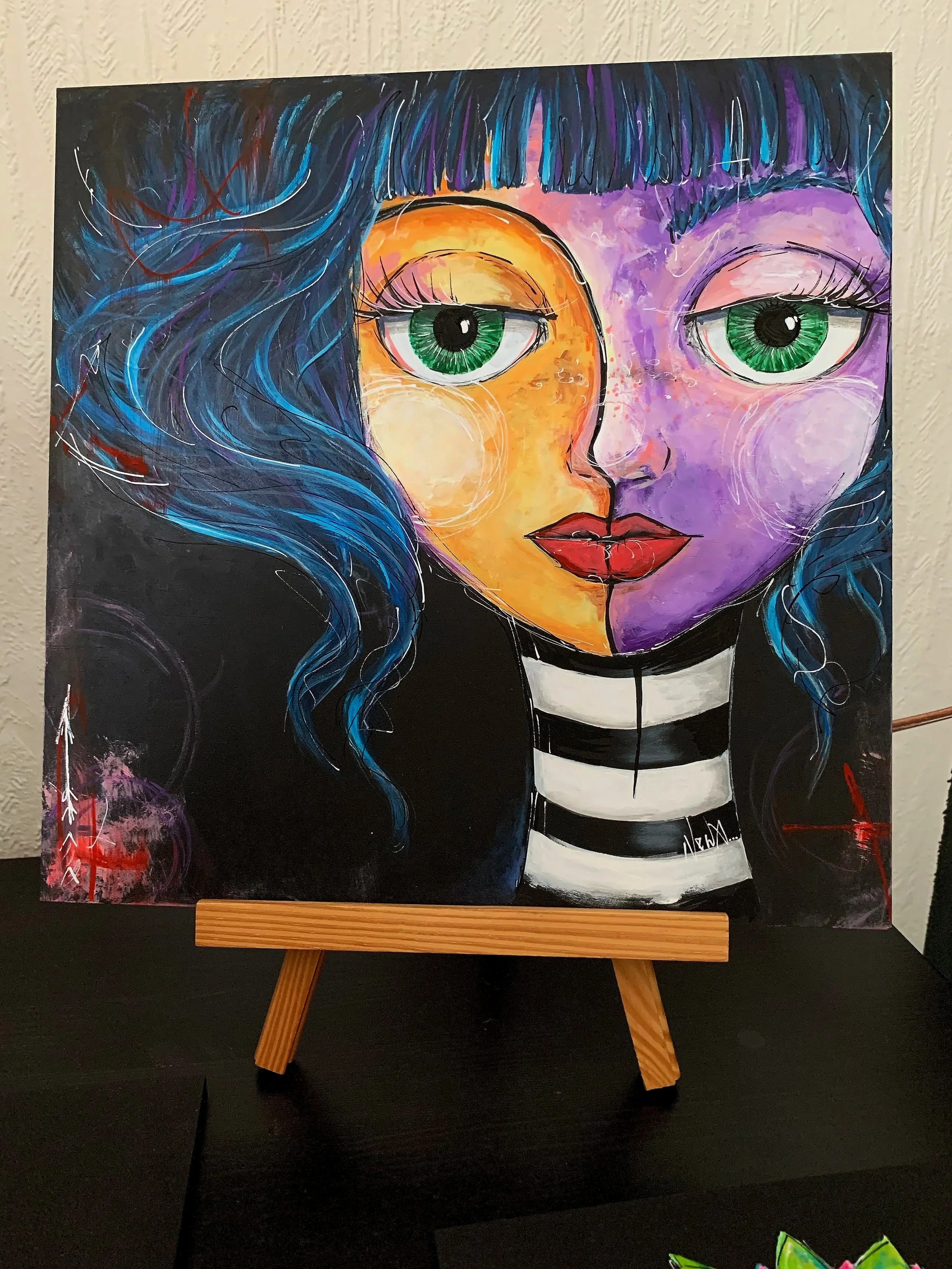 A colorful abstract portrait of a girl with large green eyes, divided face with orange and purple colors, long wavy blue hair, red lips, and a black-and-white striped shirt. She has a textured background with swirling patterns and signature markings.