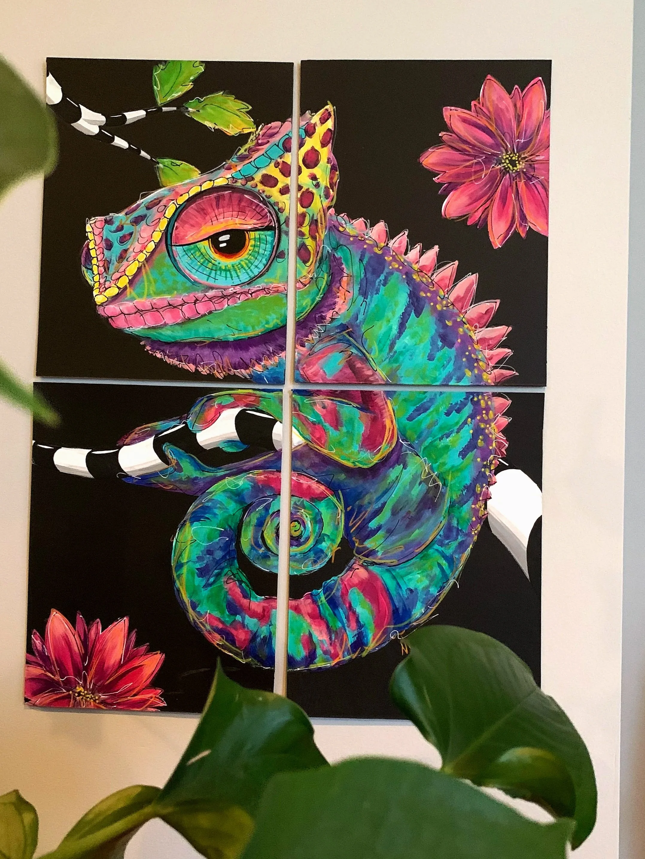 Colorful, psychedelic-style painting of a chameleon on a black background, with flowers and leaves surrounding it.