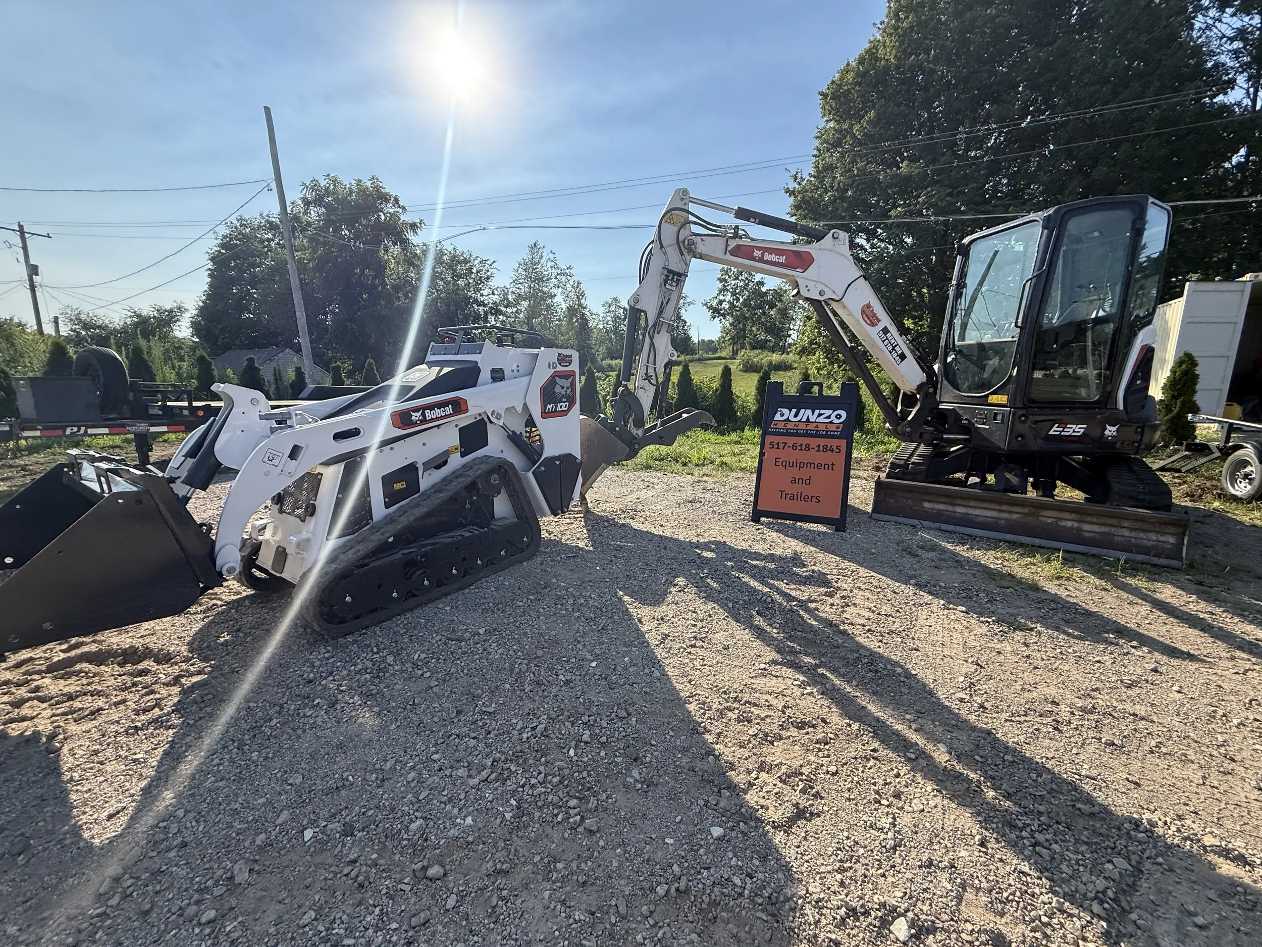 Bobcat compact track loader and E35 mini excavator displayed for rent at a construction equipment rental yard.