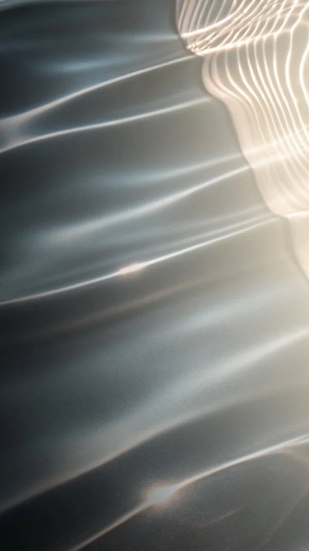 Abstract image with light streaks and reflections on a surface.