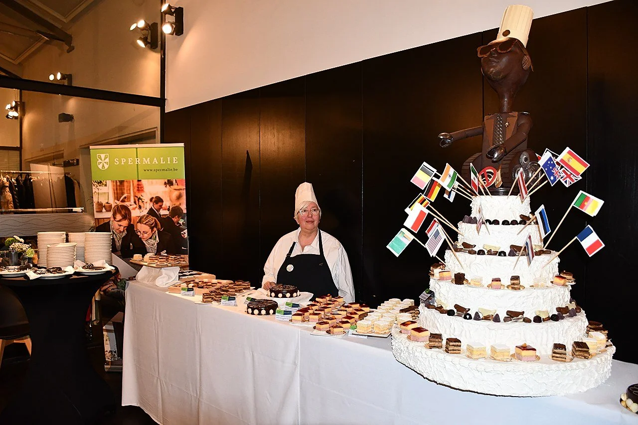 A large multi-tiered cake decorated with international flags at EUHOFA Congress Belgium 2026.