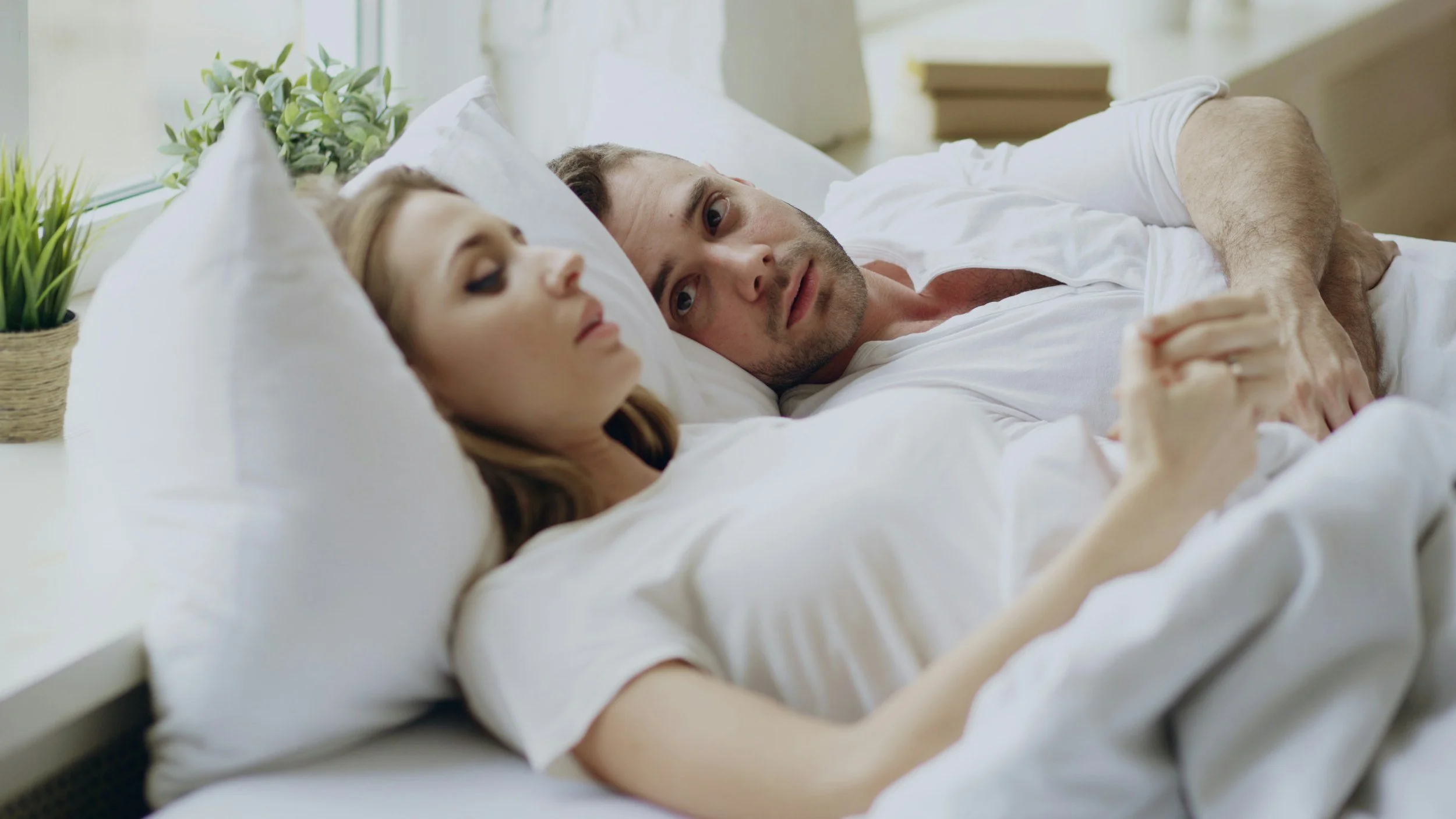troubled couple in bed