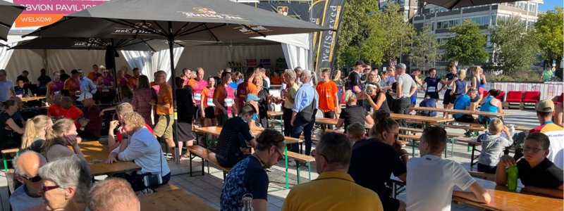 Participants enjoying food and drinks at the event village after the run and walk.