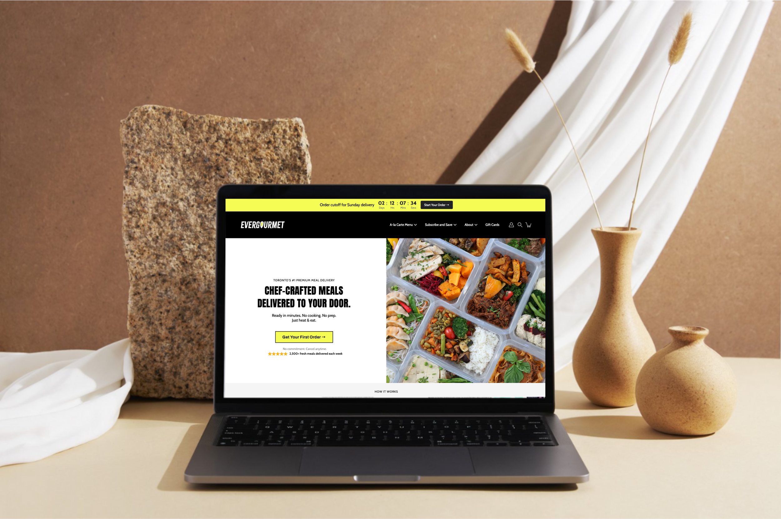 Website design for food delivery service displayed on laptop mockup