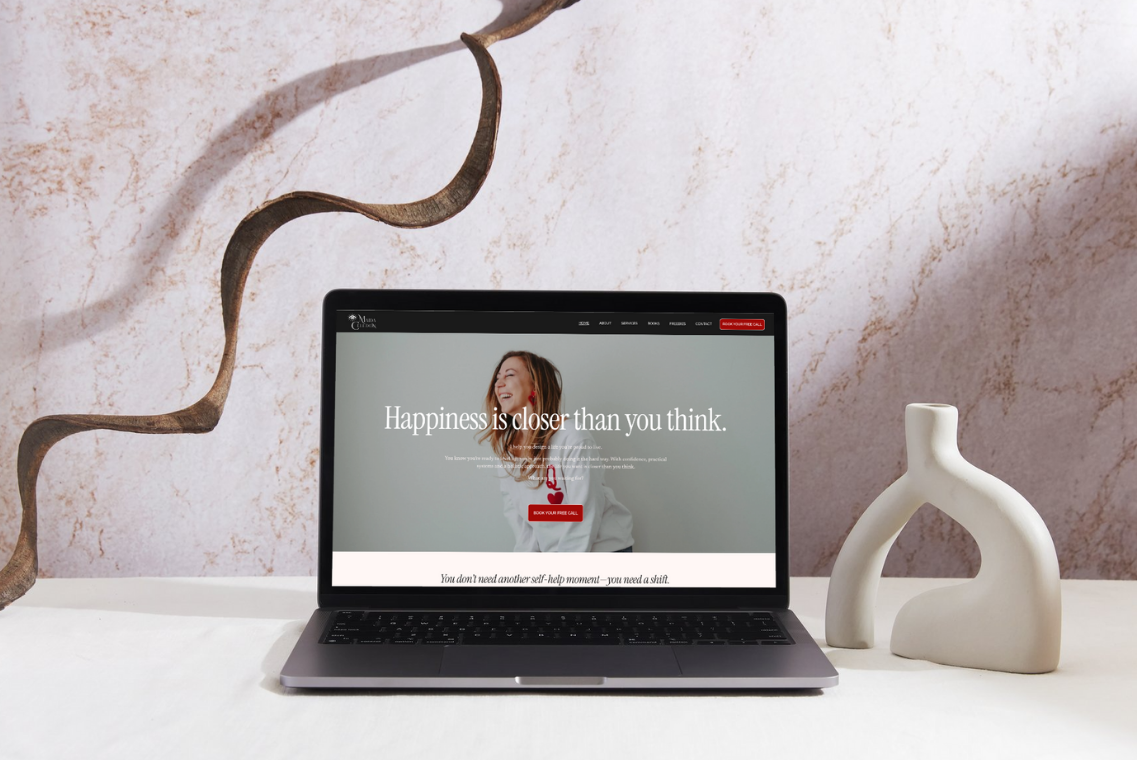 Website design for coaching business displayed on laptop mockup