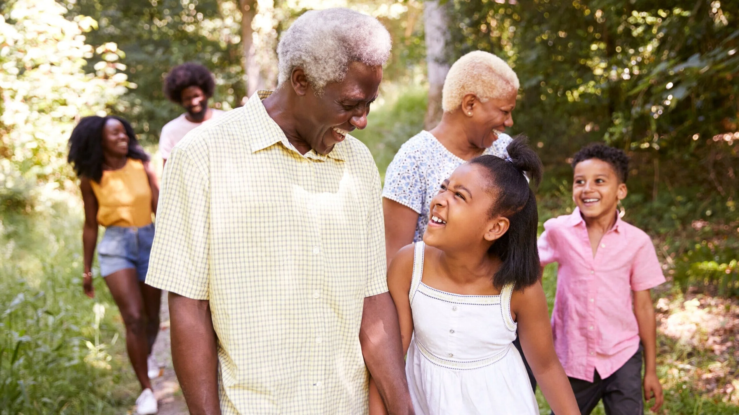 multi-generation-black-family-walking-in-forest-cl-5JY4ET8.jpg