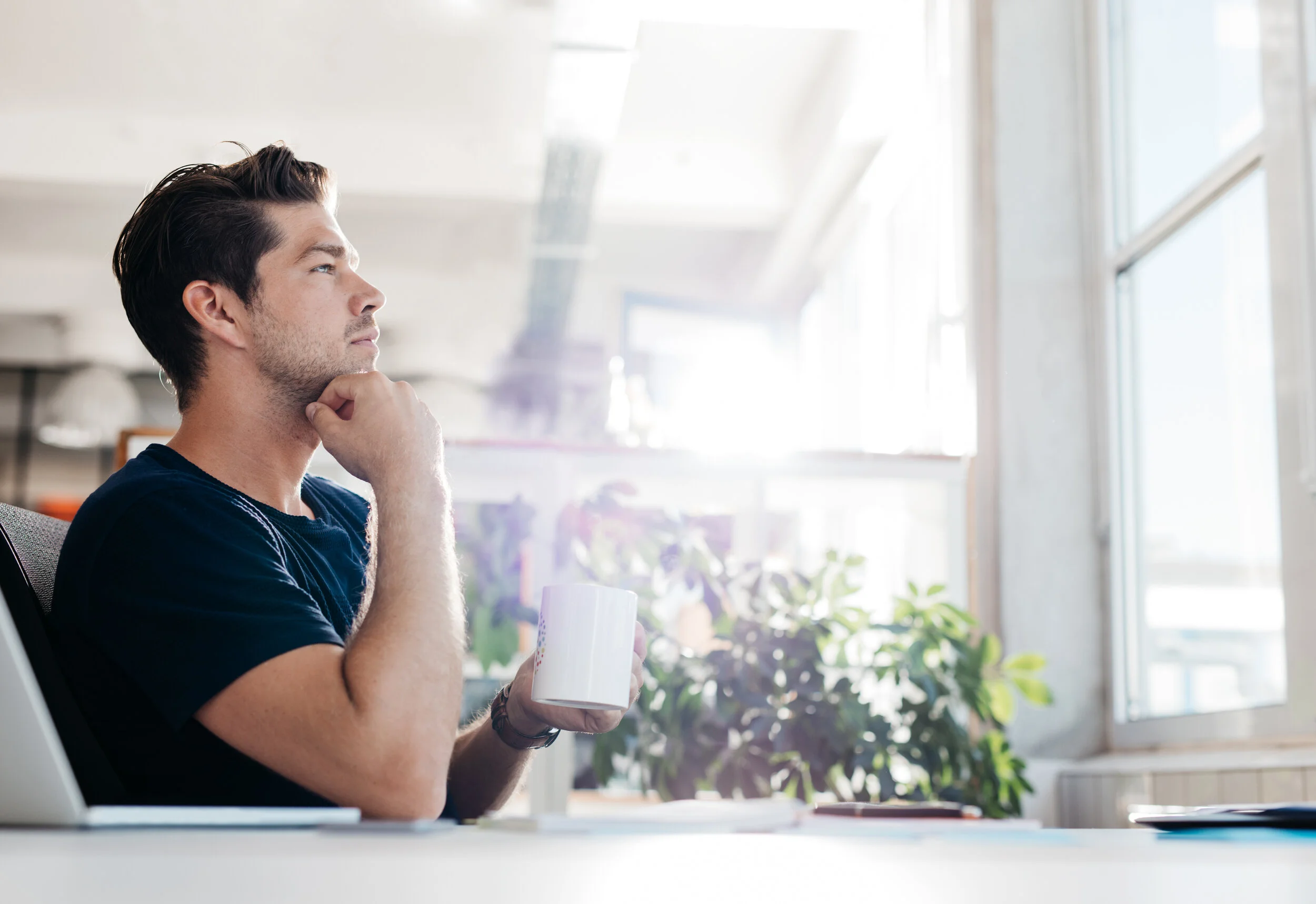 businessman-sitting-in-office-and-thinking-PKBMGA6.jpg