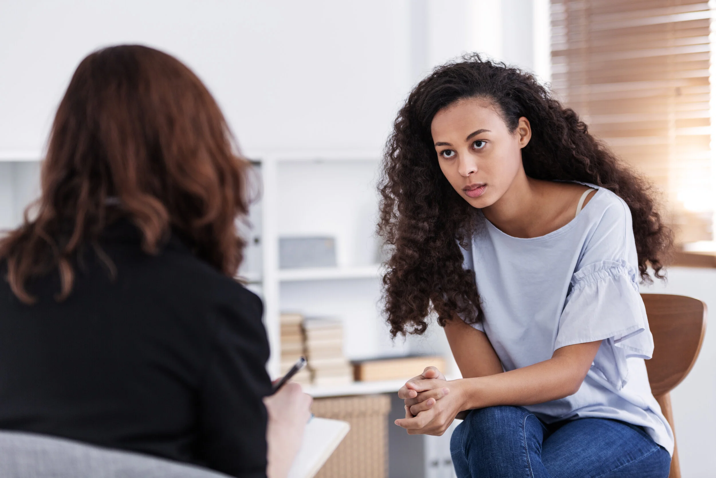 professional-counselor-and-woman-suffering-from-de-UPHRADX.jpg
