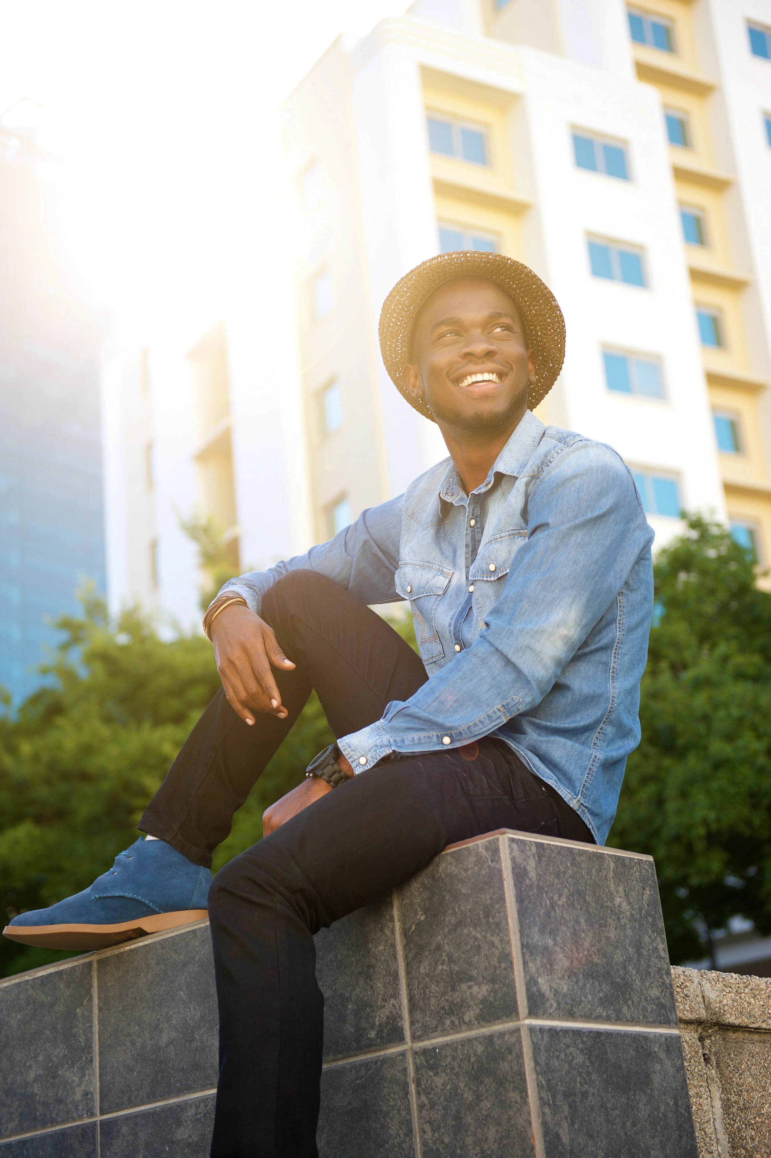 happy-man-sitting-in-the-city-P98NPDW.jpg