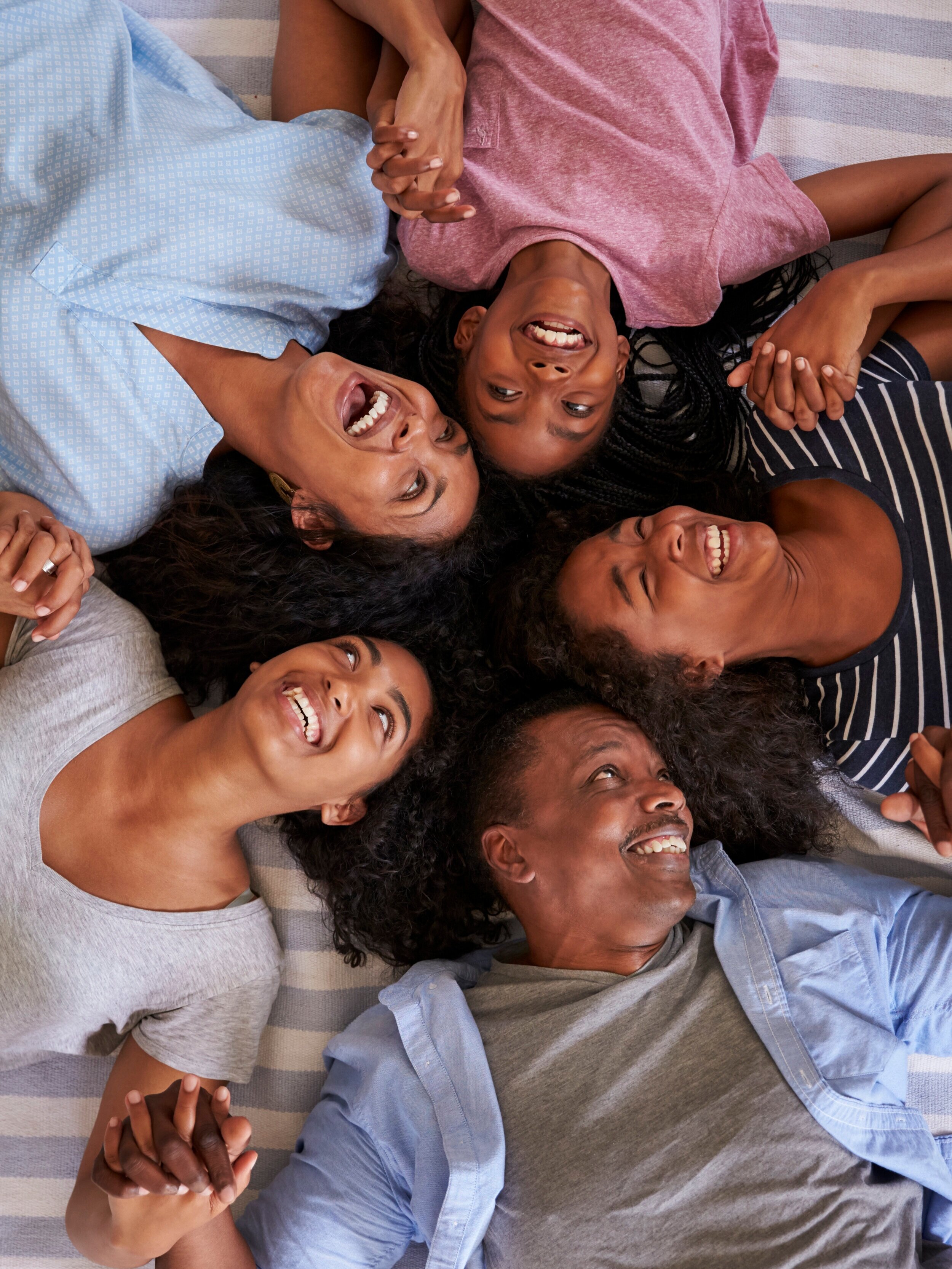 overhead-view-of-family-with-teenage-children-lyin-P8A3LSU.jpg