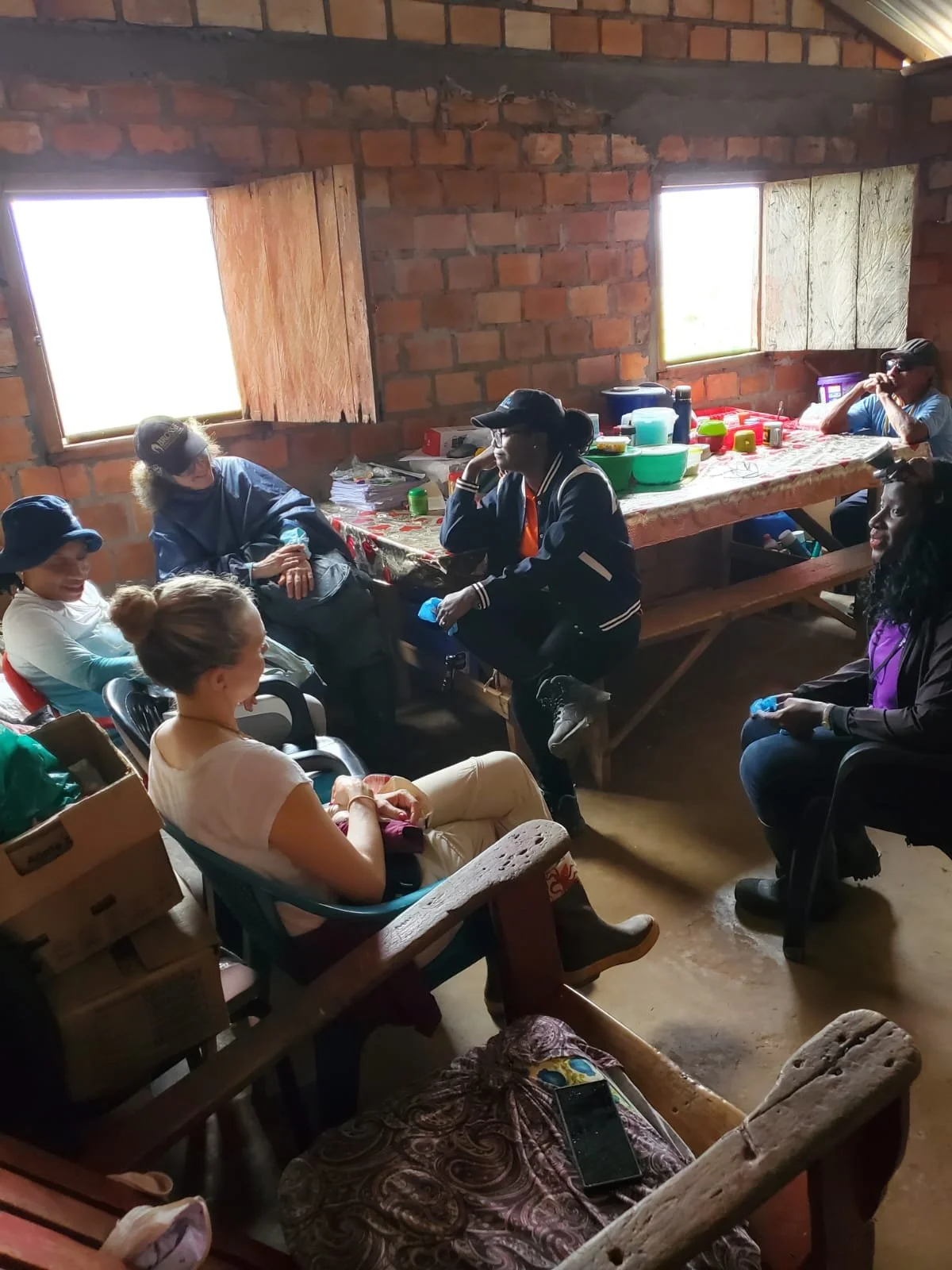 Taking shelter from the rain in the home of a community member.
