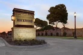 Rockwood street sign at sunset with trees and street lamp