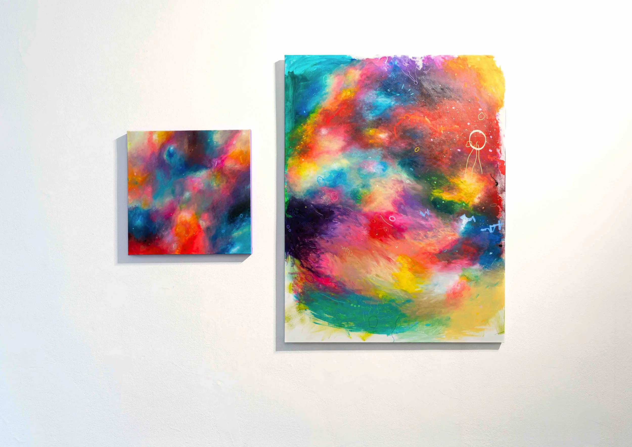 Two abstract paintings displayed side by side, with vibrant colors and layered, expressive textures