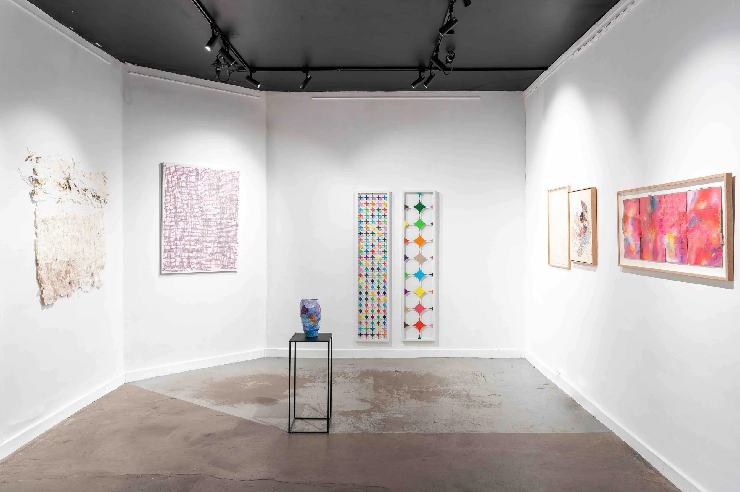 Exhibition view showing abstract artworks displayed in a contemporary gallery space