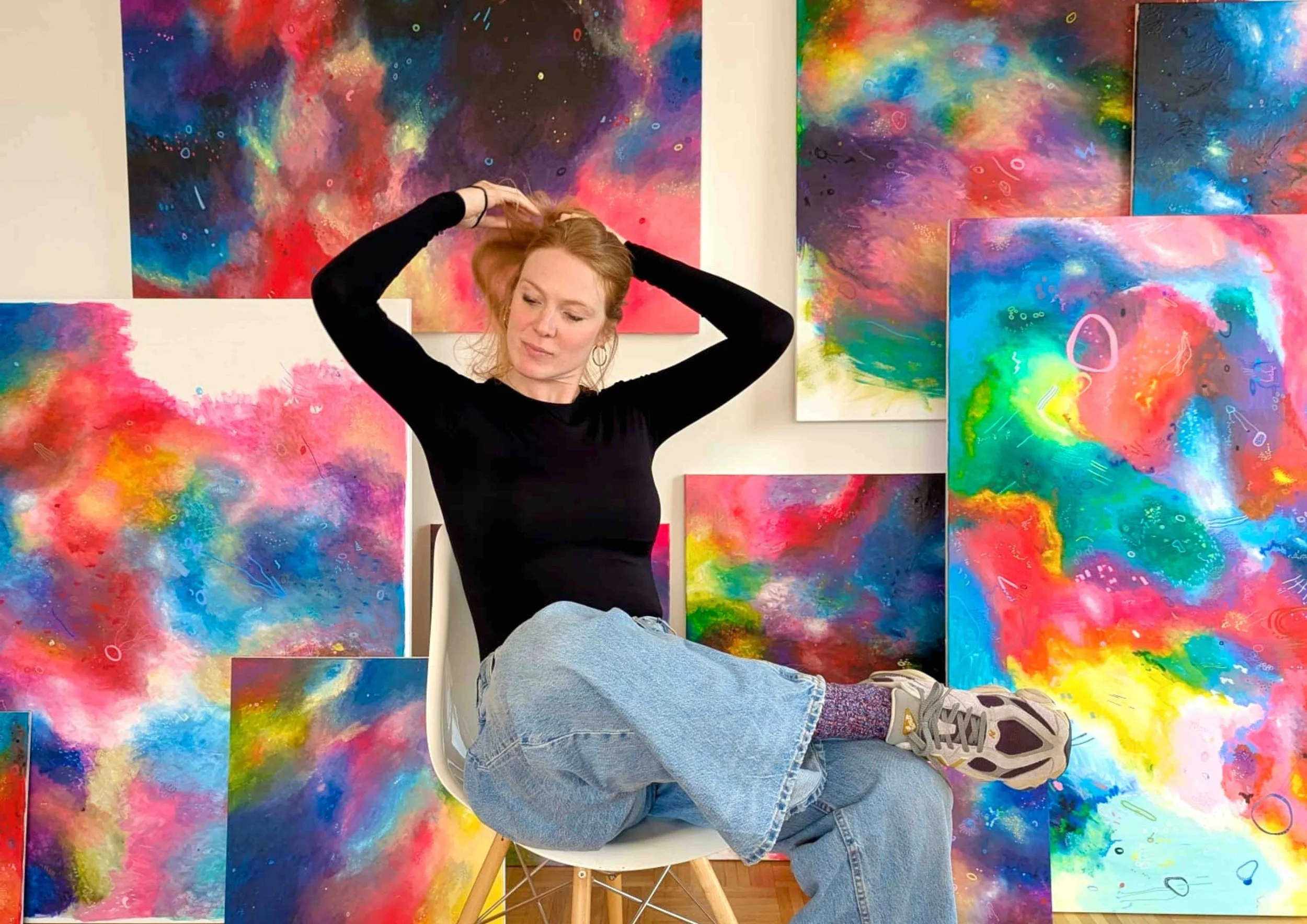 Portrait of artist Hortense Bender in her Paris studio, surrounded by abstract paintings exploring light and introspection.