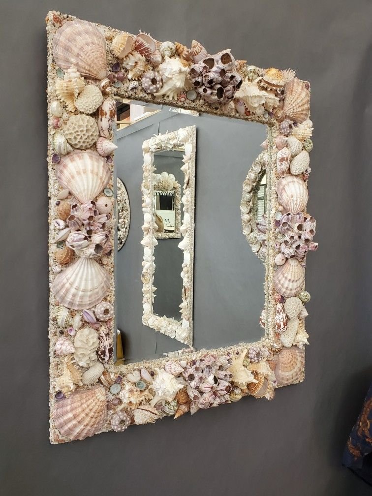 Custom shell mirror made with purple barnacles, seashells, and corals.