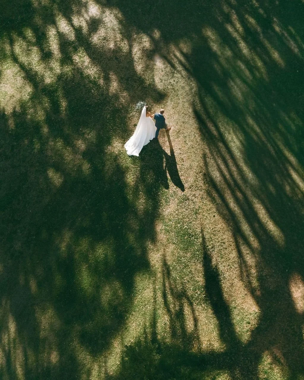 Somewhere underneath all of the planning &mdash; the timelines, the vendor calls, the logistics &mdash; there is this.

Two people. Walking together. The light through the trees casting long shadows ahead of them.

We do this work so moments like thi
