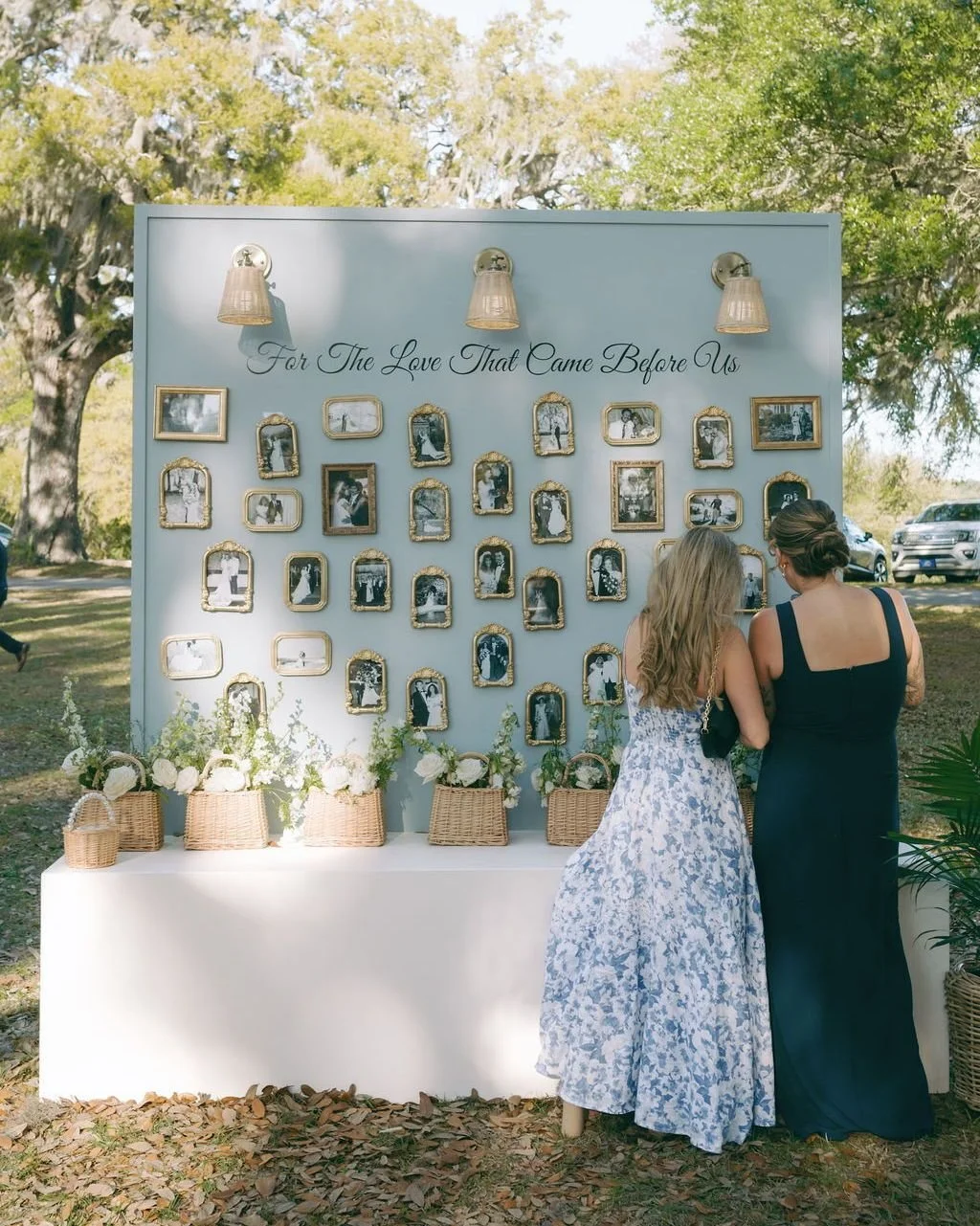 "For the love that came before us."

This wall was one of the most quietly powerful design moments of the day. Dozens of framed wedding photographs &mdash; generations of family and friend, collected and displayed &mdash; greeting guests as