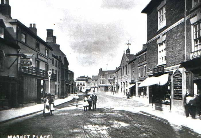 This photo is late 1800's. The clock tower has not yet been built, though the 'streetscape' of Bridge Street, Market Place and the corner of Wash Lane (Queens Road) are instantly recognisable.