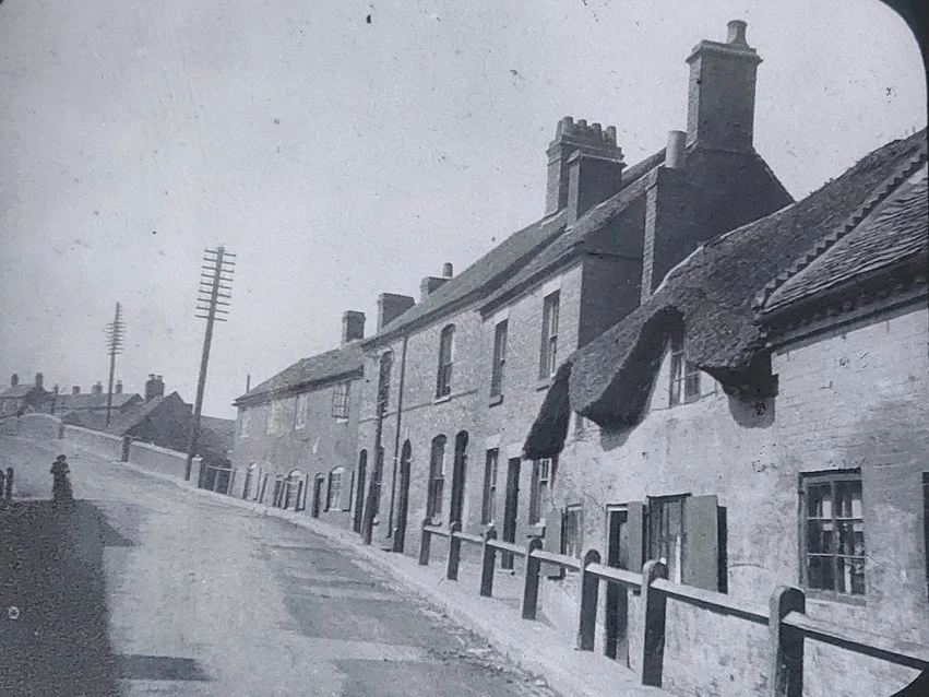 Bridge Street at Bull Ring, Nuneaton, leading up to the canal bridge over the Coventry Canal.  Even today, a hundred years later, this street scene is immediately recognisable. On the left-hand side now stands Bridge Street Sheltered Housing Complex,