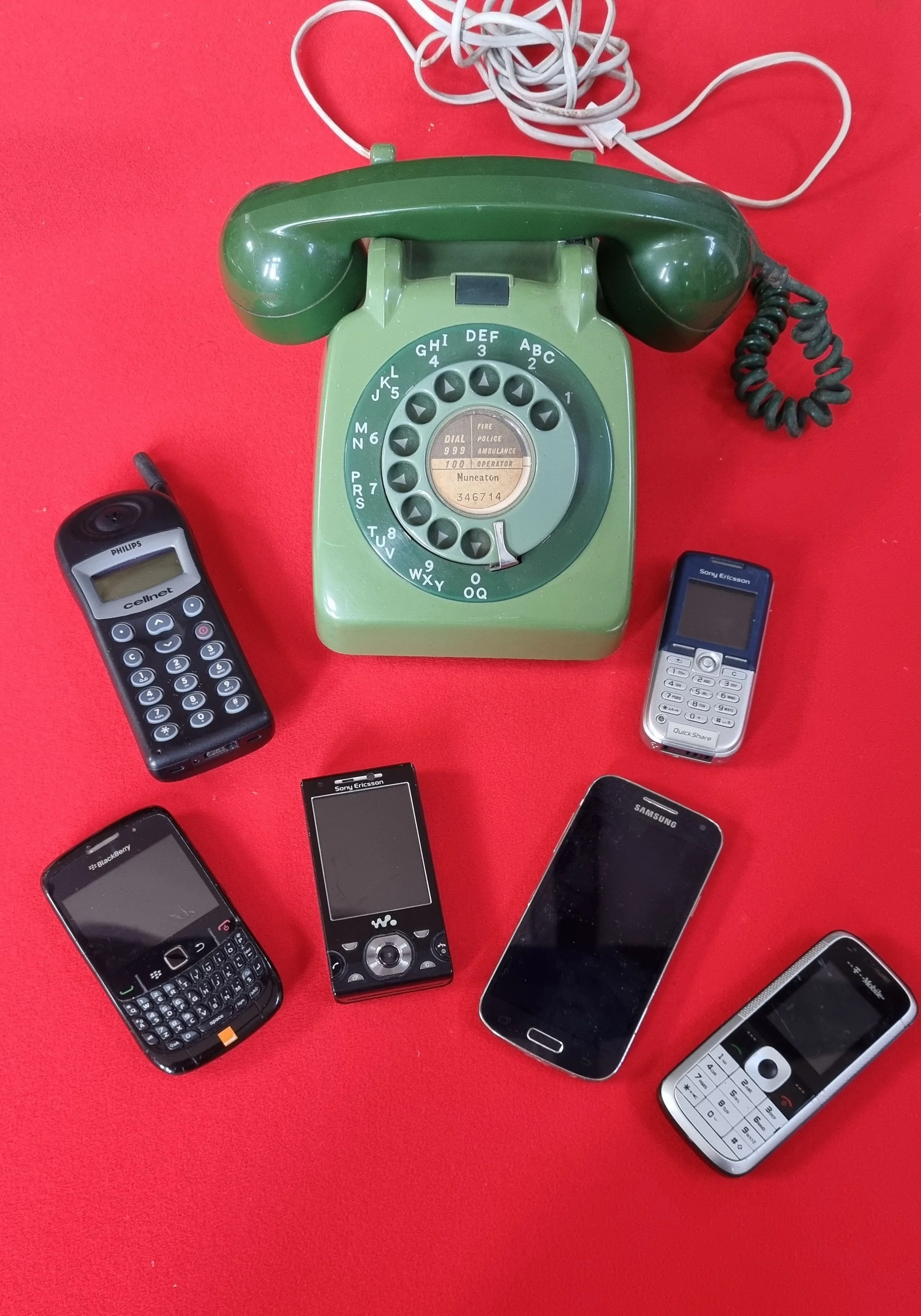 Selection of telephones through the ages, including GPO rotary land line, Phillips Cellnet mobile unit late 1990’s, with phone and text messaging to the extremely popular Blackberry smart phone, circa 2007, with QWERTY keypad with email capability.