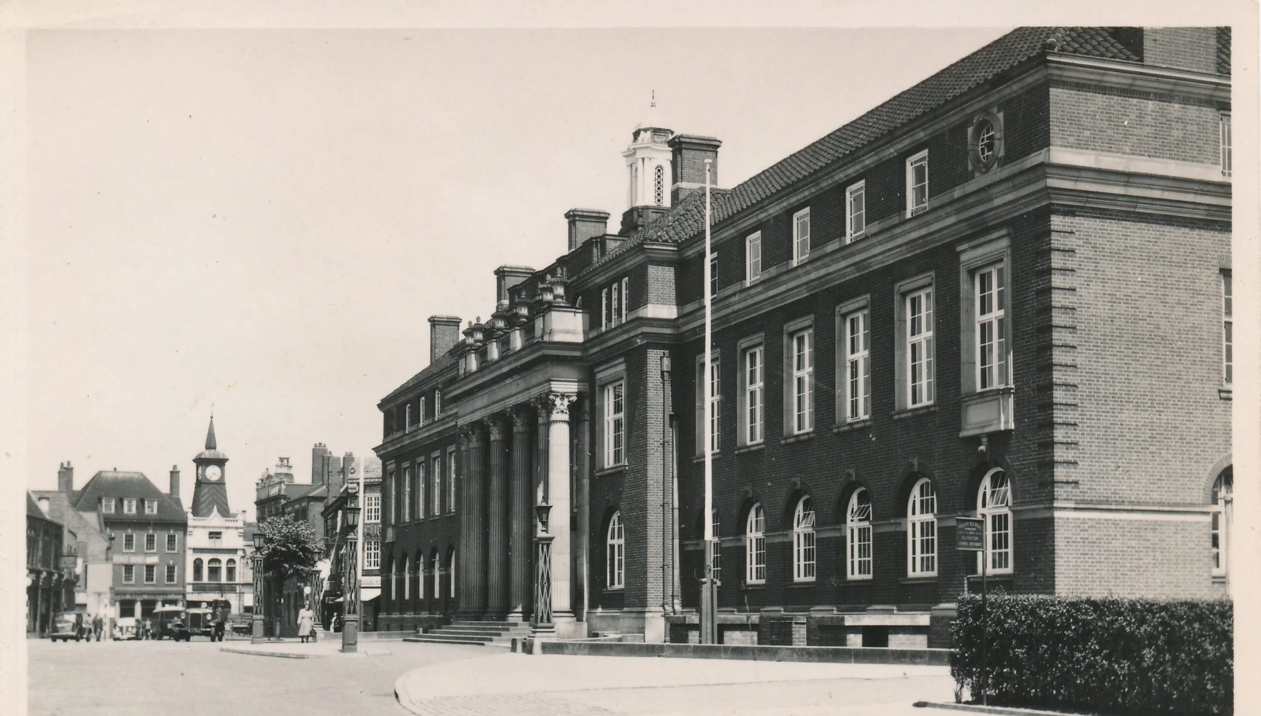 The Town Hall before the alterations were carried out with the removal of the flagpoles, pavement widening and the creation of the disability access ramps.  The card is unfranked but looks to be 1950’s.