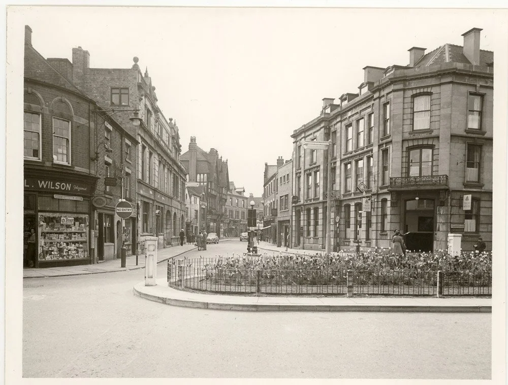 The view from outside J C Smiths looking across to the Newdegate Arms Hotel on the corner of what is now the Harefield Road/ Newdegate Street junction. The hotel was demolished in the 1960's clearances and the Heron Arcade built on the site. The Hero