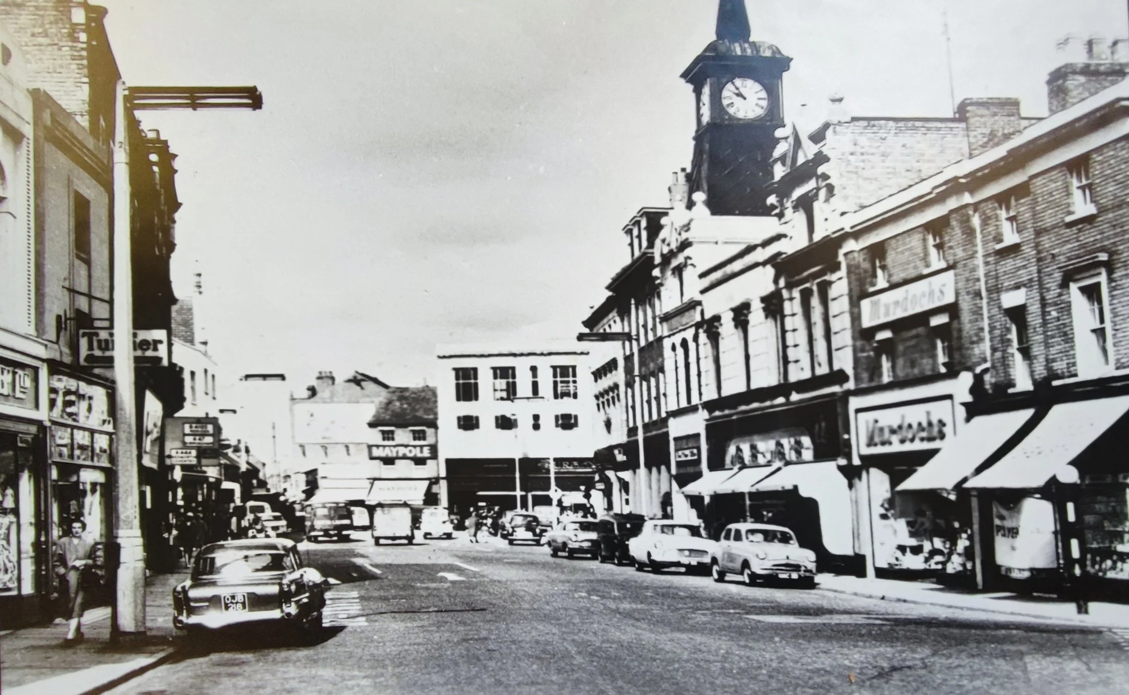 Market Place in the 1960's. At the bottom of Market Place can be seen Burtons and the Maypole. It's only 10.00am but the town is busy, lots of cars parked up. No traffic wardens back then.