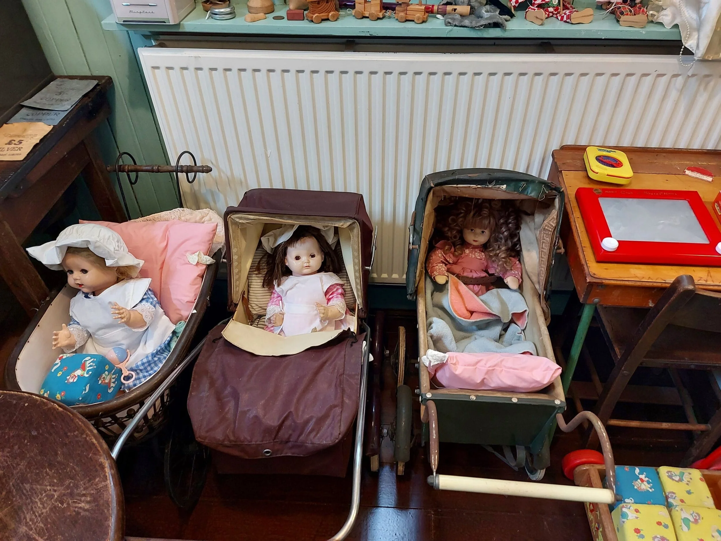 Selection of children’s dolls and prams.