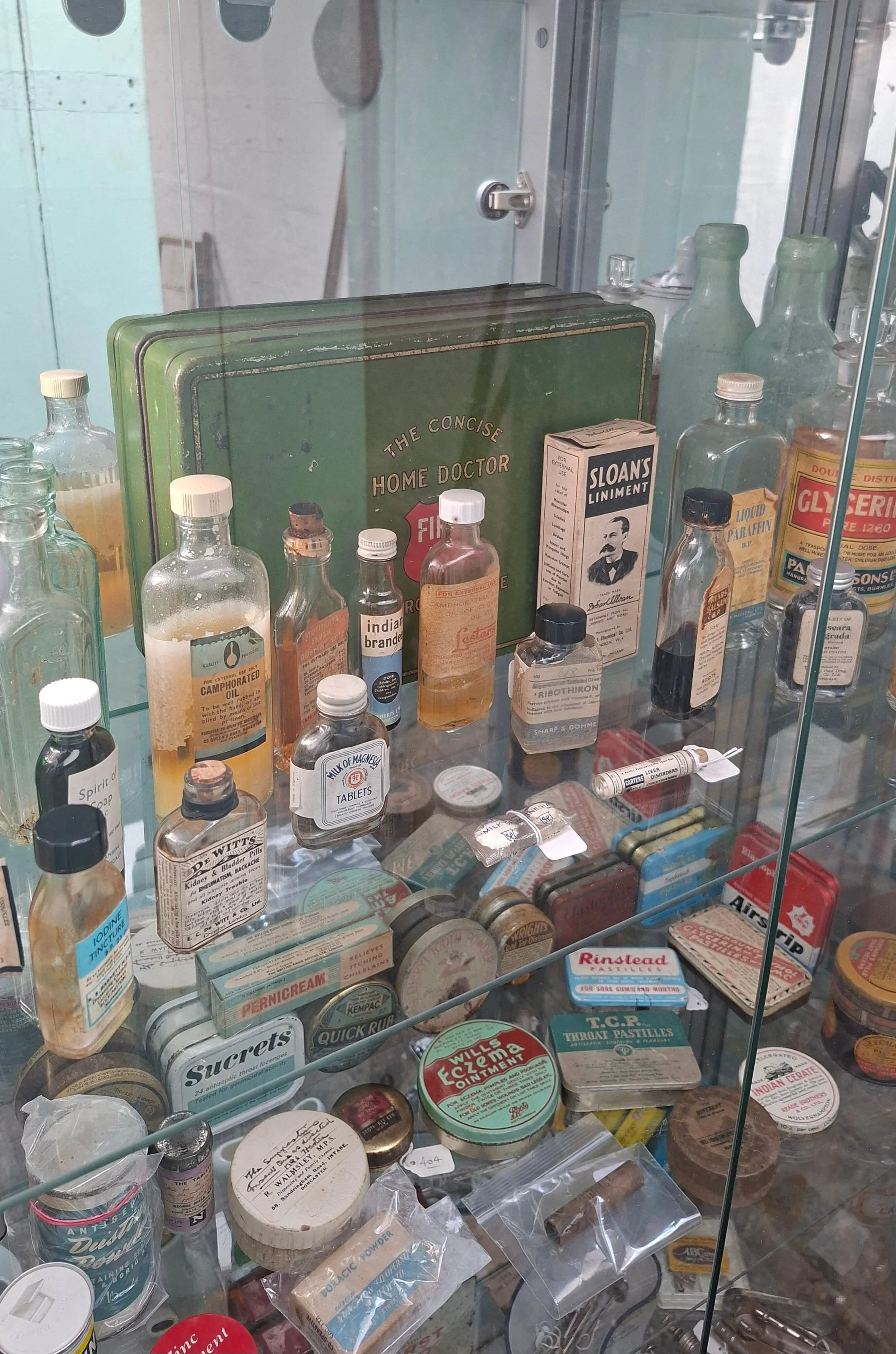 Selection of medicines and over-the-counter creams to treat common ailments in the early to mid 20th century was available at the local chemist.