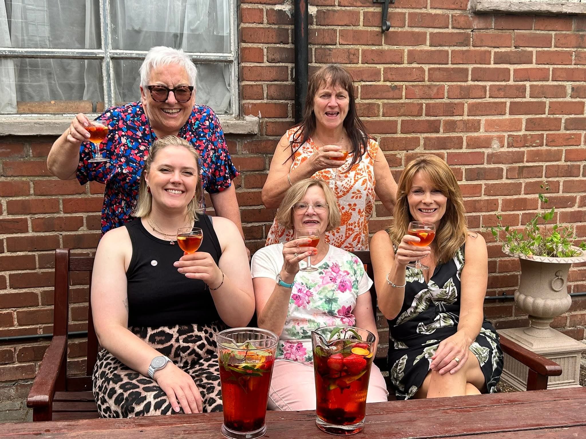 five females raising glasses