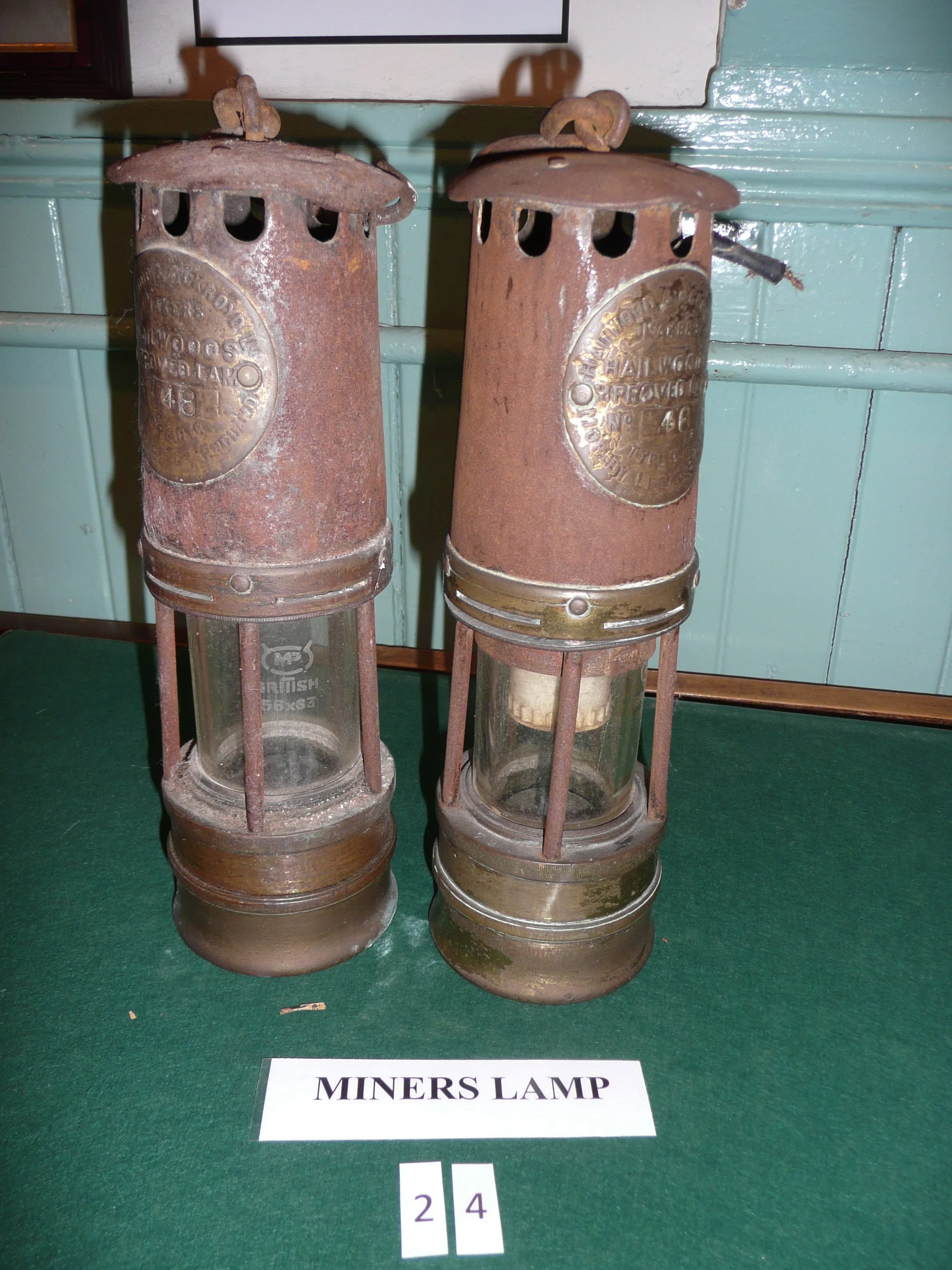Halewood miners' safety lamp was designed to illuminate the pitch-black depths of a coal mine and provide safety for the miners. These examples are manufactured by Hailwood & Ackroyd in Morley and Leeds in the early 20th century.
