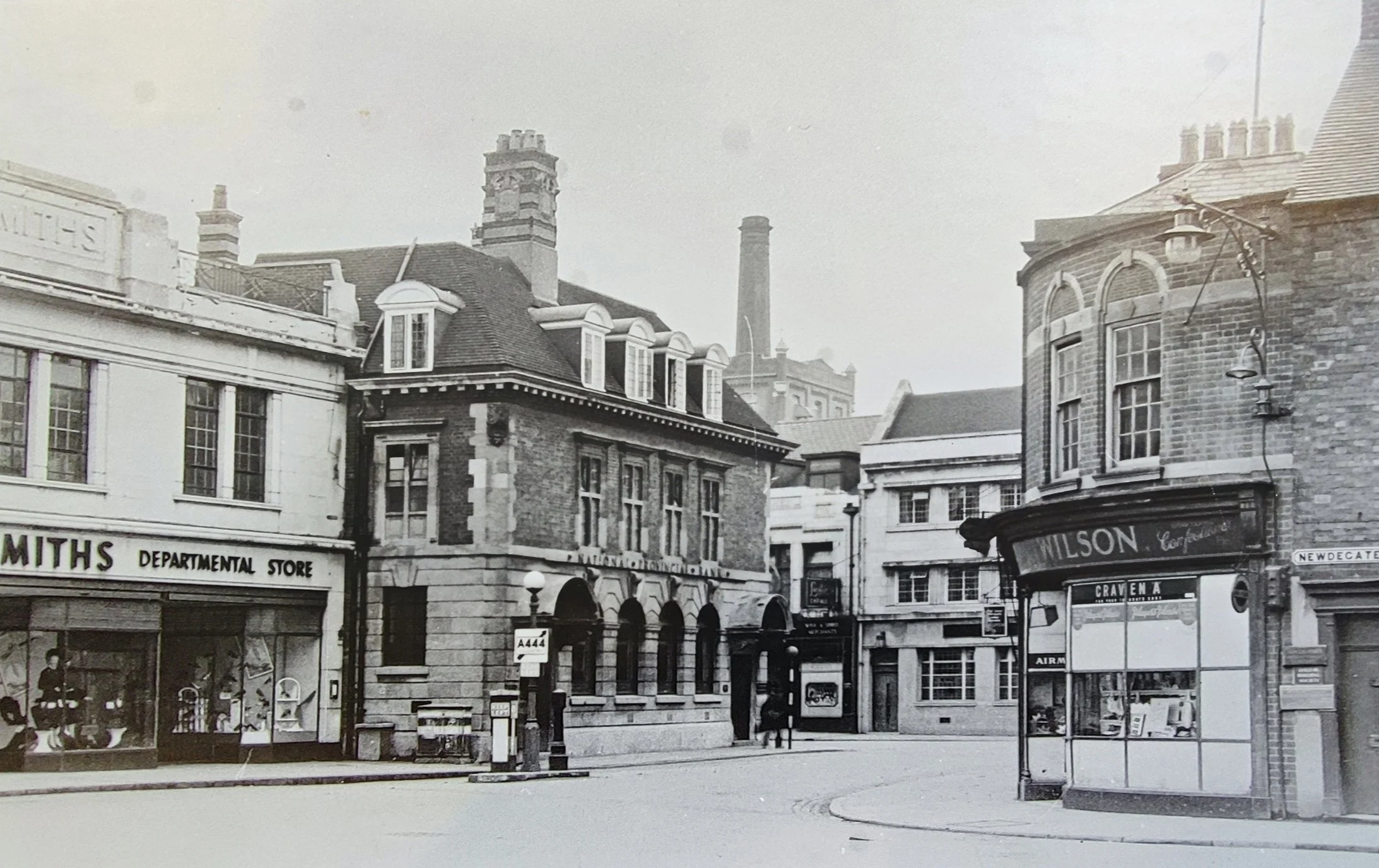 J C Smiths in Newdegate Square sometime in the late 50's or early 60's. In the background you can see the Nuneaton Flour Mill and its chimney. Next to Smiths is the National Provincial Bank, later to become the Bradford and Bingley Building Society. 