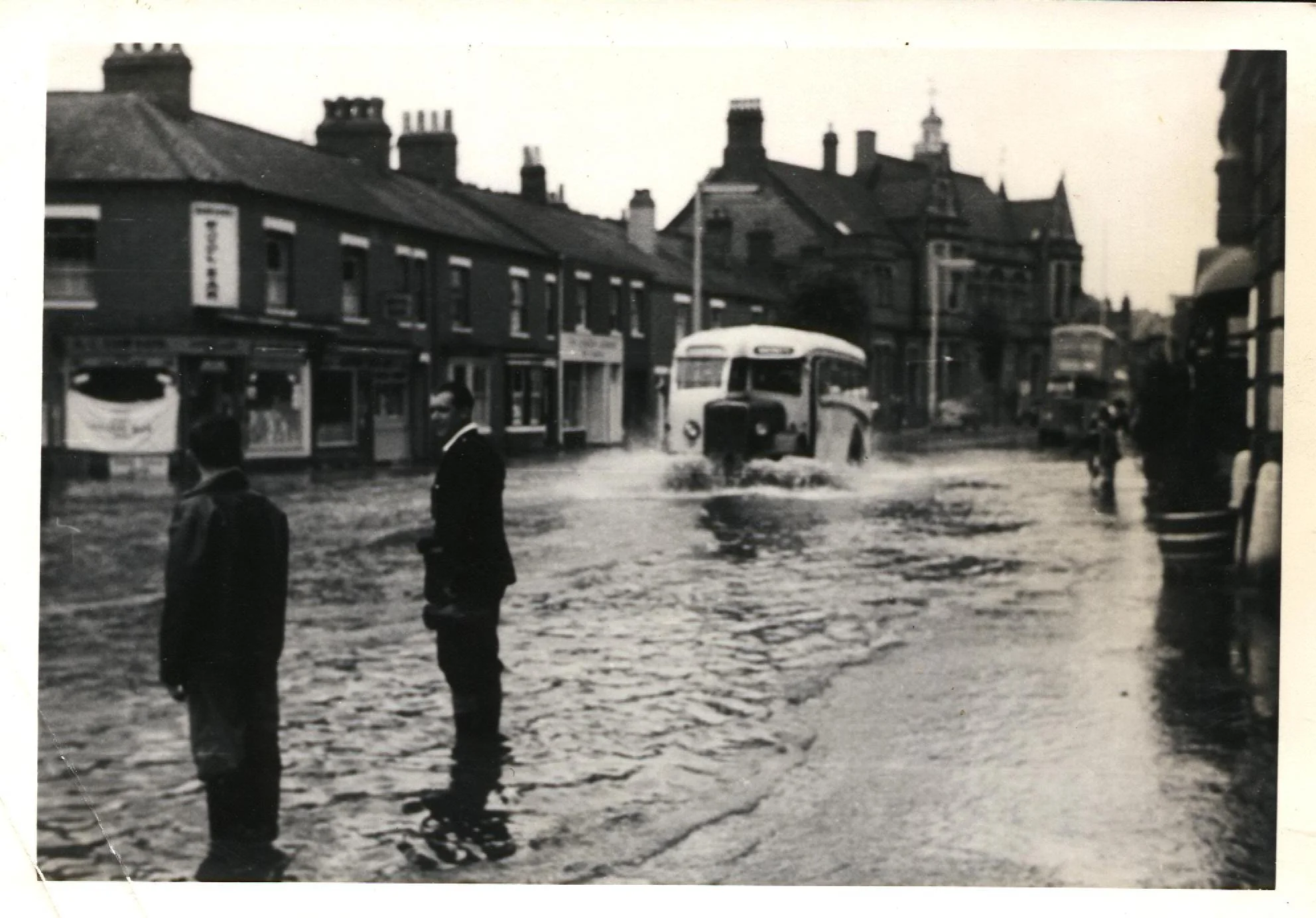 Coventry Street in the 1950's (possibly 1958) showing the flooding which was not uncommon. In the background you can see the old Police Station (now Virgin Bank), next to it is Armstrongs and the first of the small houses is Evolve Hair Stylists. All