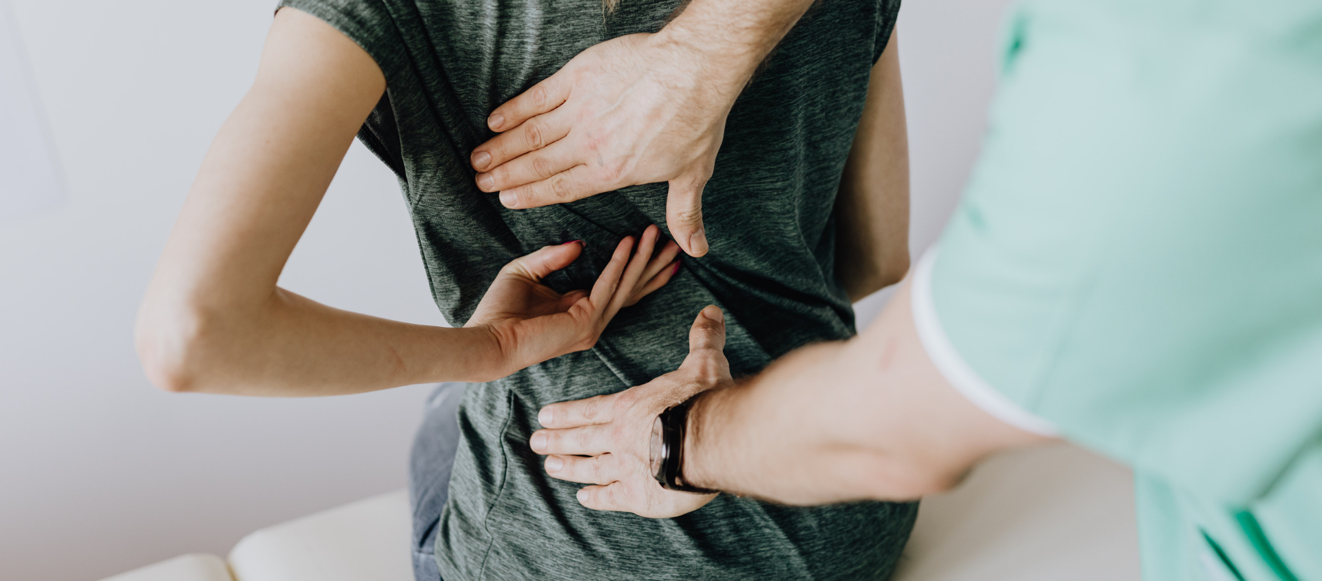 Medical professionals performing a chest examination on a patient.