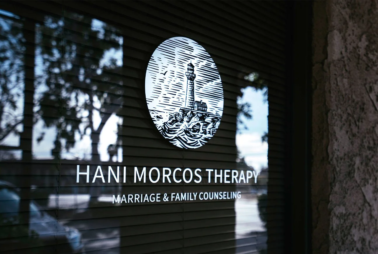 Picture of Hani Morcos logo on the window of his practice office.