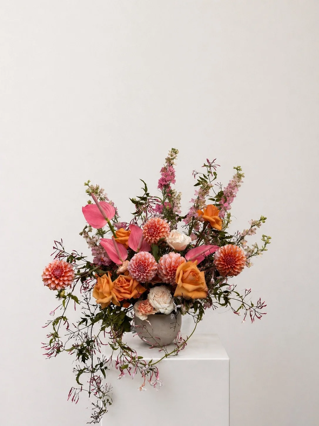 Modern floral arrangement by San Diego wedding florist Isla Flor featuring vibrant seasonal flowers in a white vase.