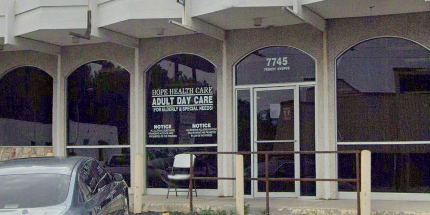 Exterior view of Hope Health Care Adult Day Care facility with signage and parked car in front.