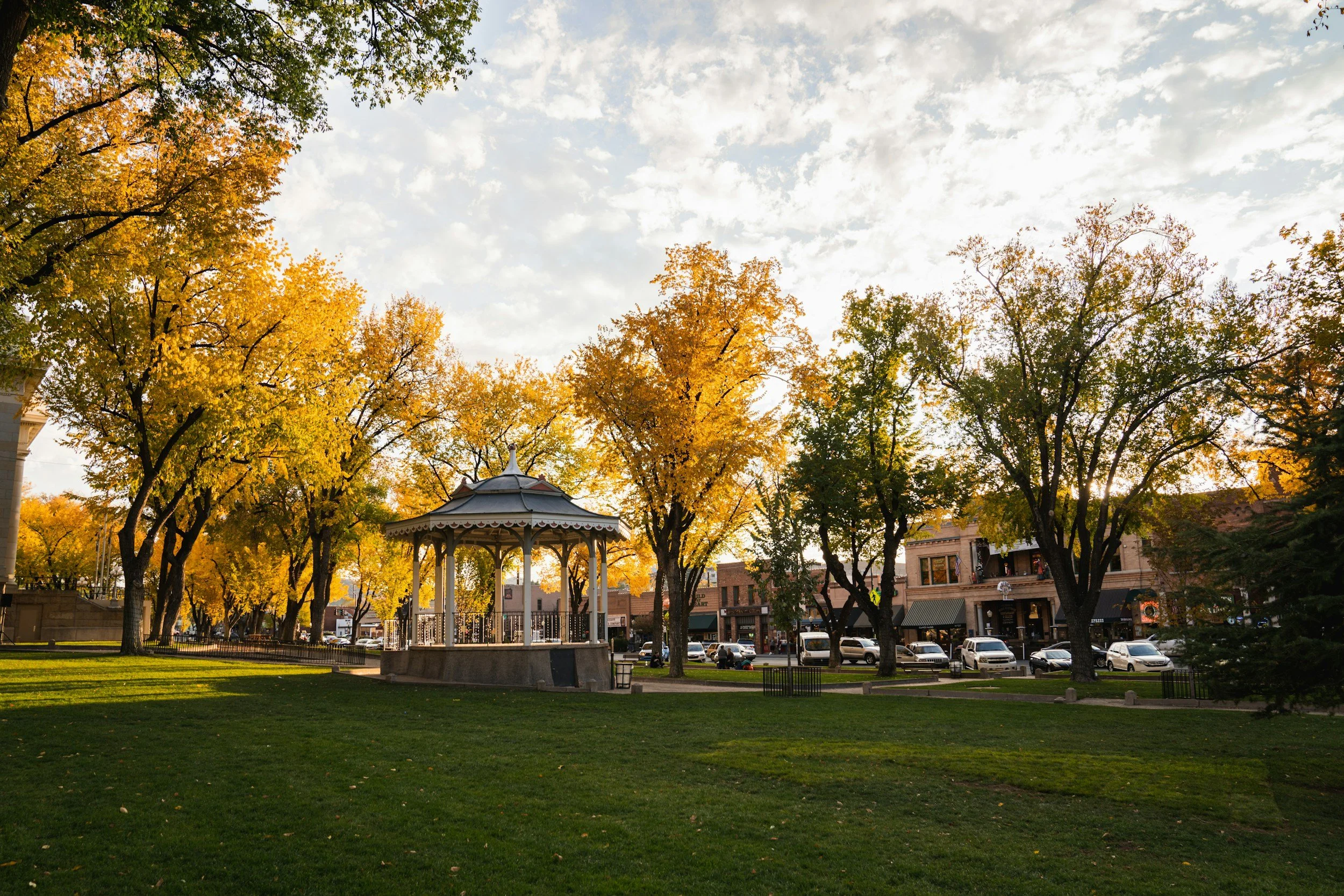 Small-town park with a gazebo and autumn trees