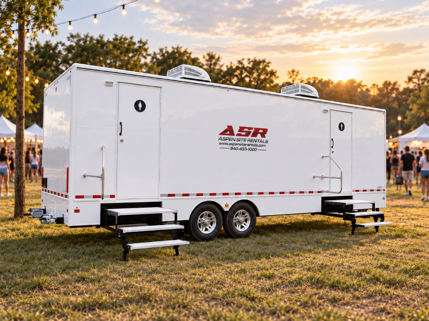 Rendering of a long luxury restroom trailer with a red stripe at a sunset festival