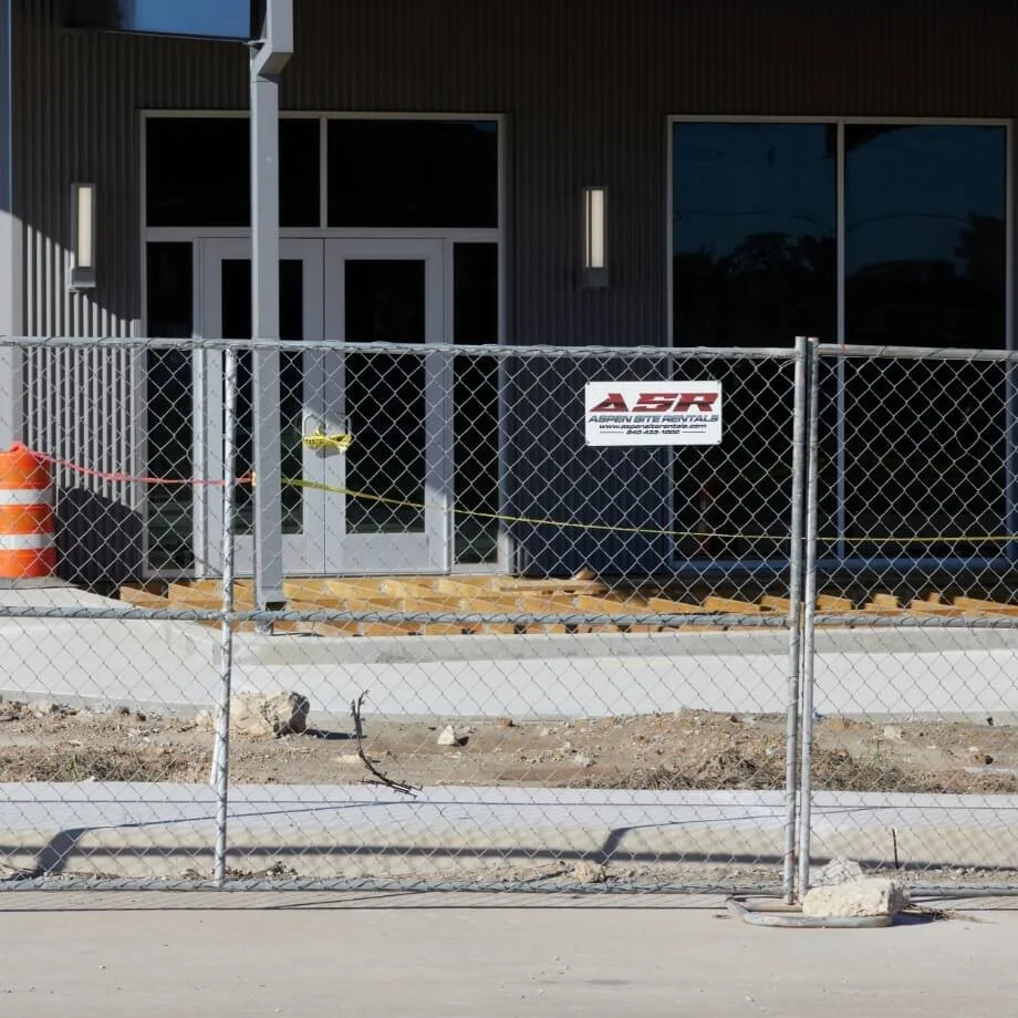Temporary chain-link fence panels at a commercial building site