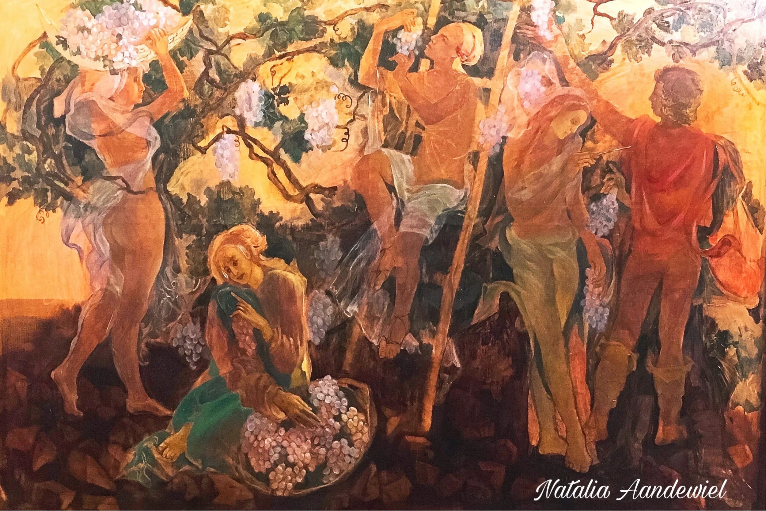 A painting depicting several women with light skin and dressed in flowing garments, harvesting and gathering grapes in a vineyard. The background features grapevines with clusters of grapes, all rendered in warm tones of yellow, orange, and brown.
