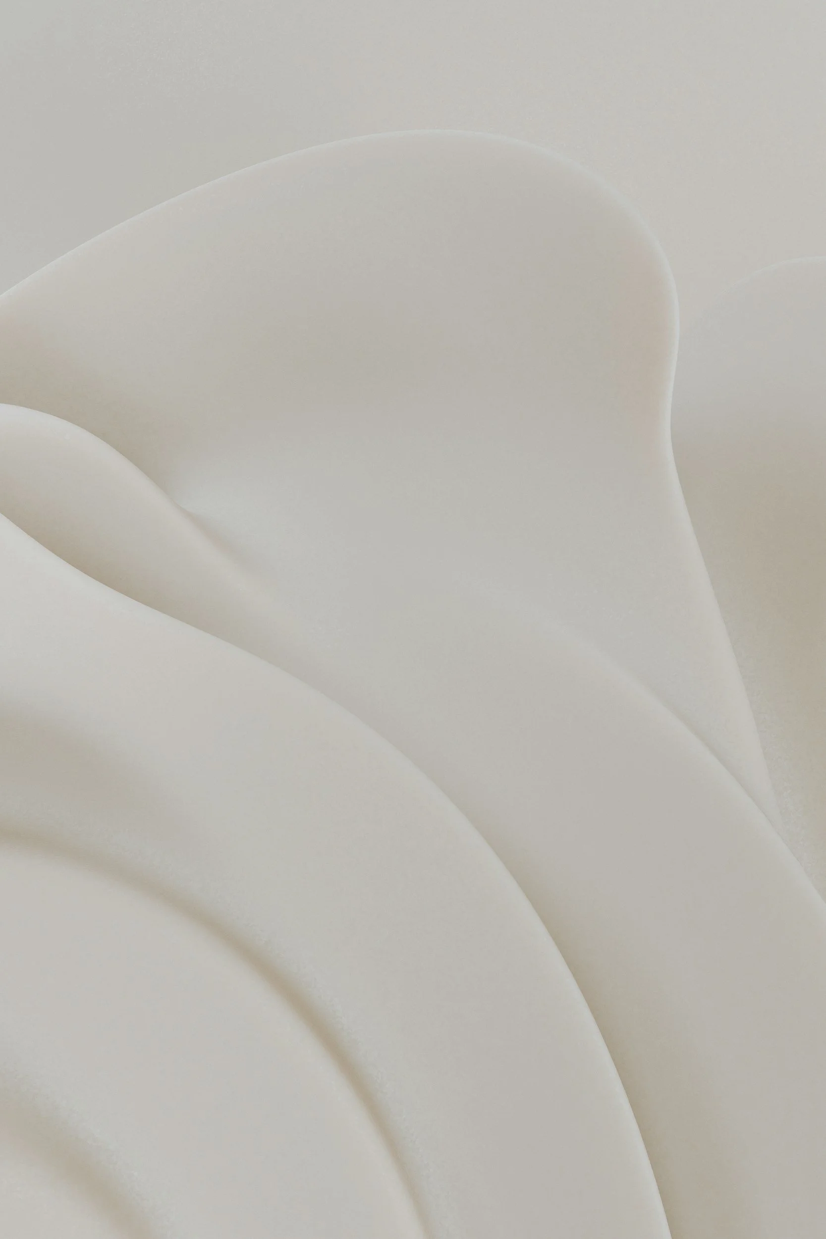 Close-up of white origami paper shaped into soft, overlapping curves.