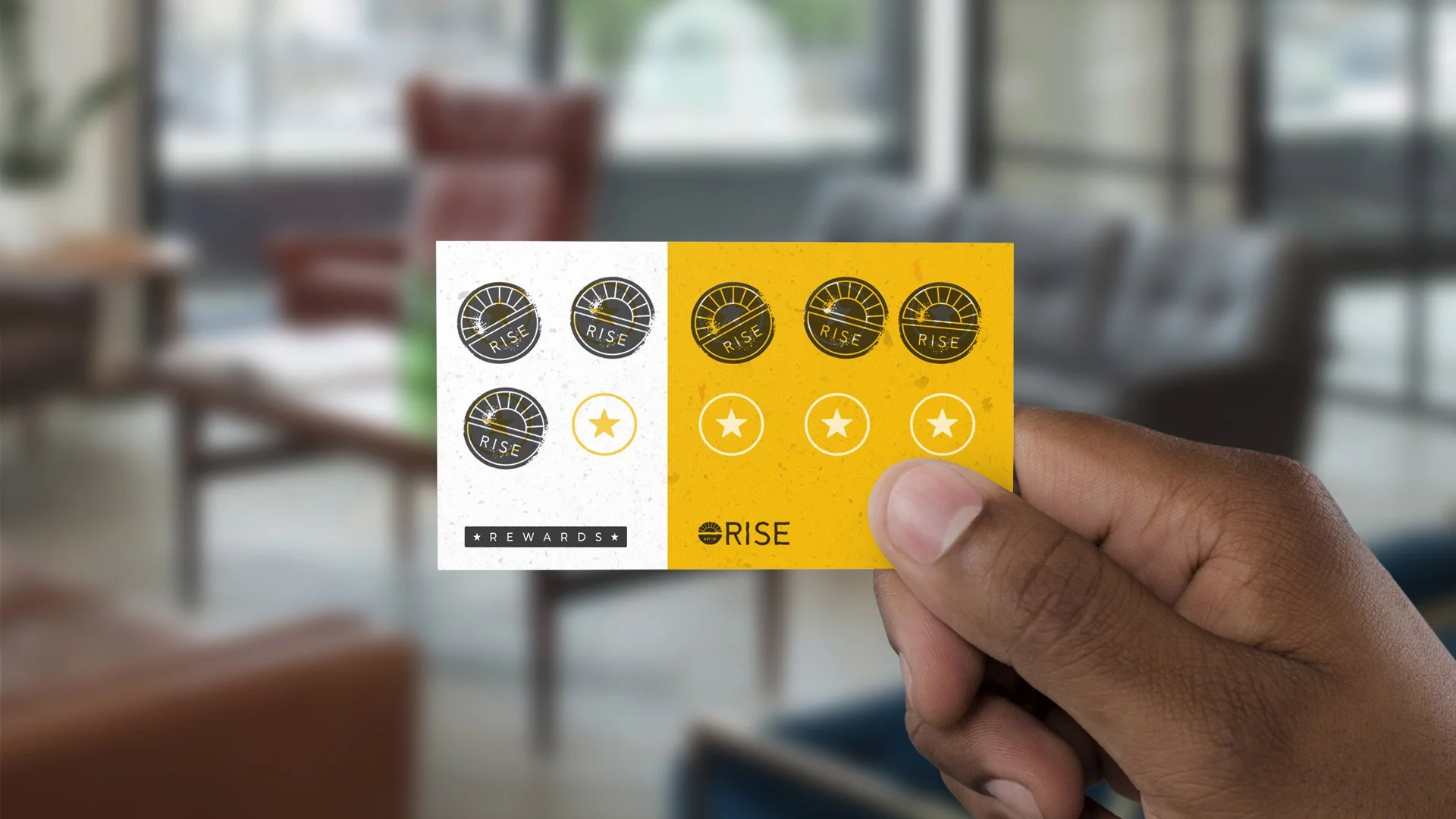 Hand holding rewards program card with stamps covering 6 of 10 reward points.